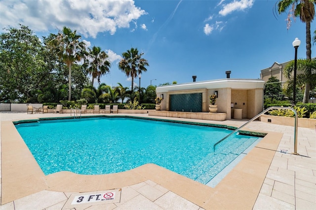 community pool featuring a patio area and fence