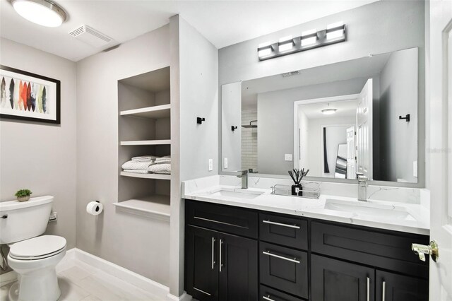 full bathroom featuring toilet, visible vents, and a sink