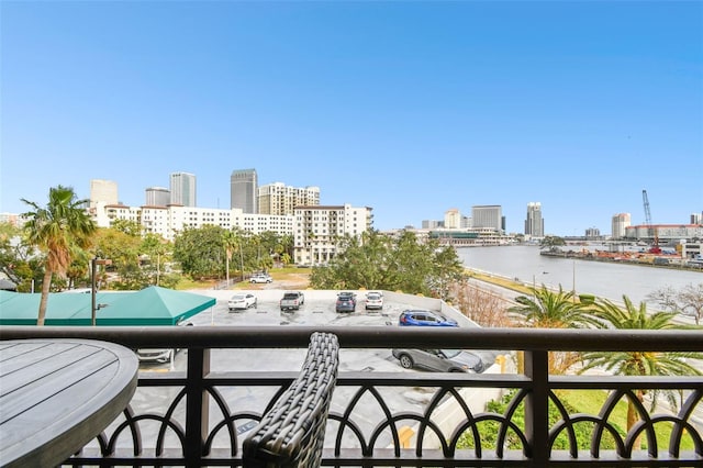 balcony with a view of city and a water view