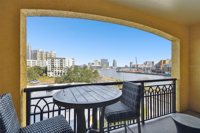 balcony featuring a city view and a water view