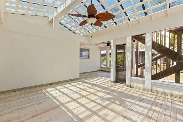 deck with a ceiling fan and stairs