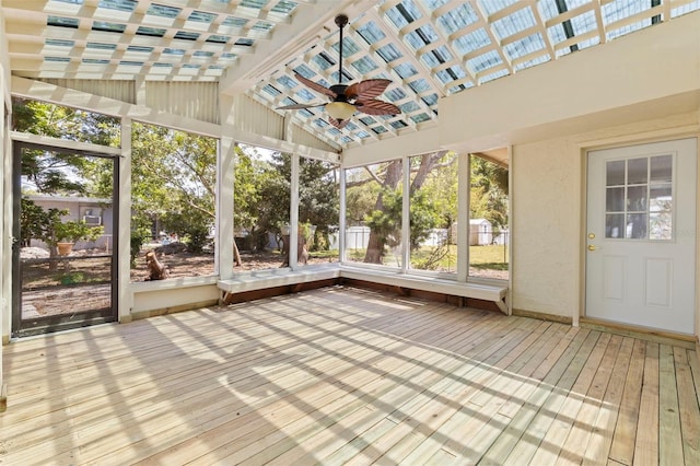 unfurnished sunroom featuring ceiling fan and beamed ceiling