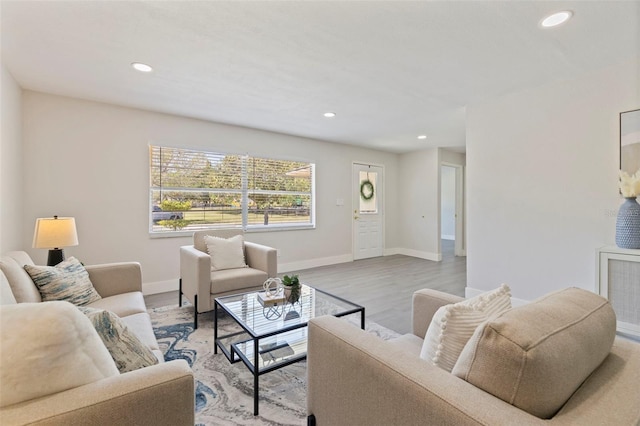 living area with wood finished floors, baseboards, and recessed lighting