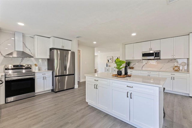 kitchen featuring backsplash, light countertops, wall chimney exhaust hood, and stainless steel appliances