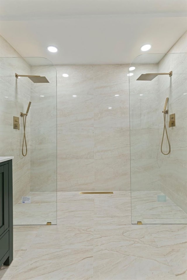 bathroom with recessed lighting, vanity, and a walk in shower