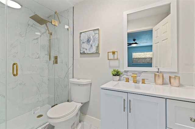 bathroom with toilet, vanity, a marble finish shower, and baseboards