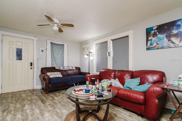 living room featuring ceiling fan and wood finished floors