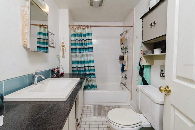 full bathroom featuring toilet, shower / tub combo, visible vents, and vanity