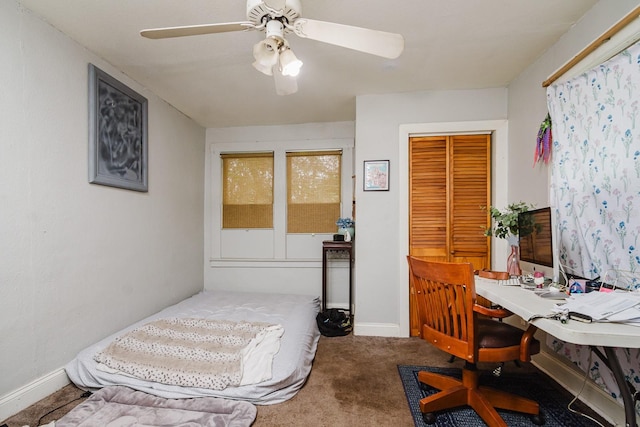 bedroom with ceiling fan, carpet flooring, and baseboards