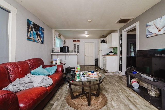 living room featuring wood finished floors and visible vents