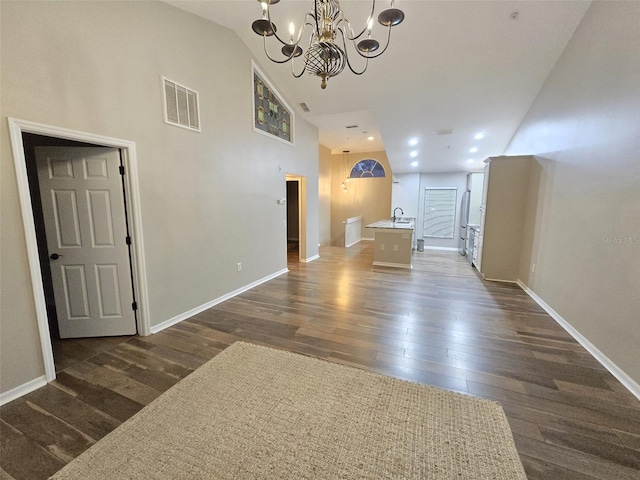 interior space with baseboards, visible vents, and dark wood-type flooring