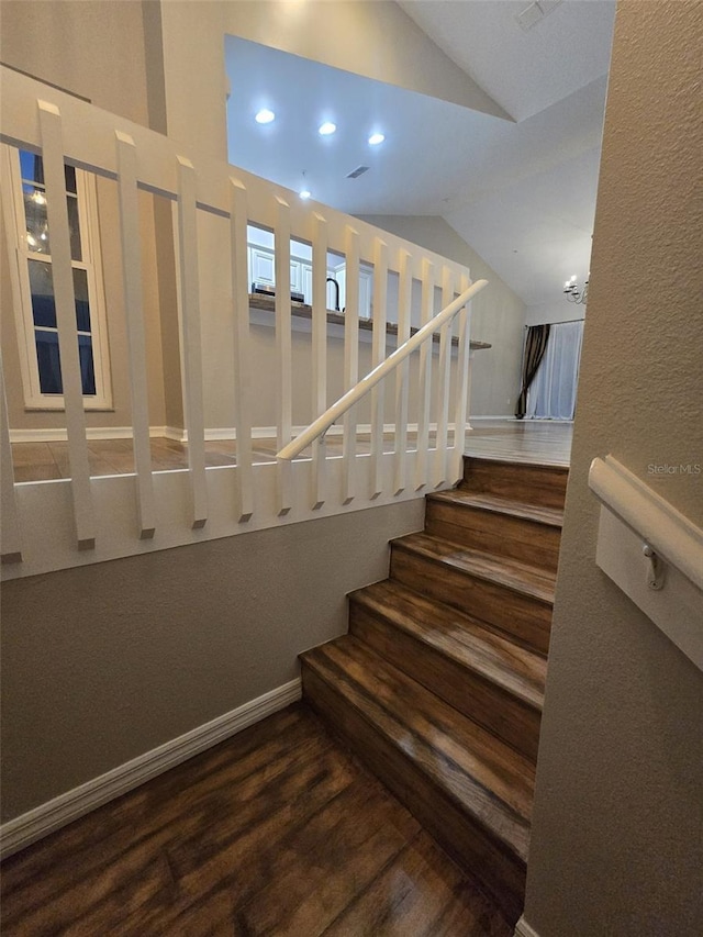 stairs with recessed lighting, vaulted ceiling, baseboards, and wood finished floors