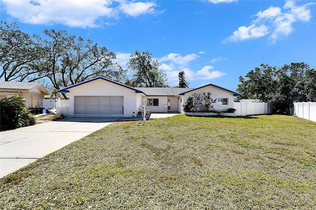 ranch-style home with a garage, a front yard, fence, and driveway