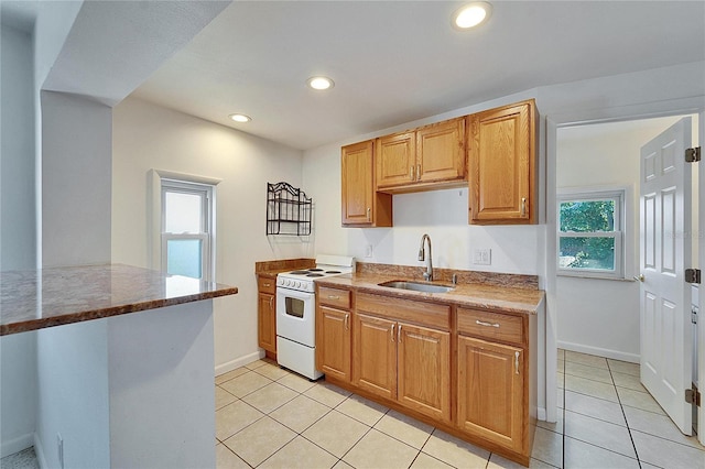 kitchen with dark stone countertops, light tile patterned flooring, white electric range, a sink, and recessed lighting