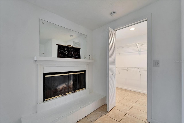 interior space with a glass covered fireplace