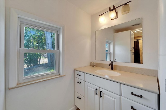 bathroom with visible vents, plenty of natural light, and vanity