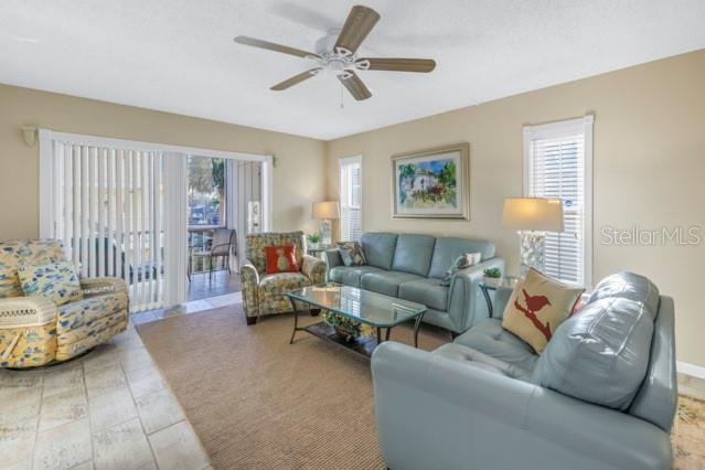 living area with a ceiling fan and a healthy amount of sunlight