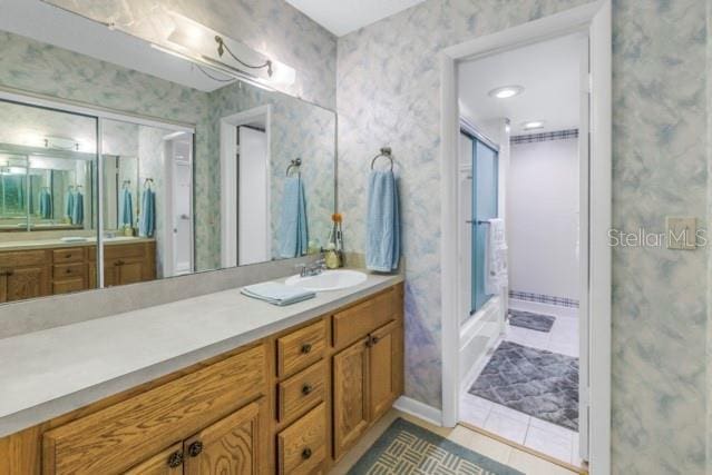 full bathroom featuring tile patterned floors, vanity, and wallpapered walls