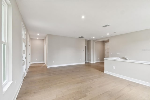 spare room with light wood-style floors, recessed lighting, visible vents, and baseboards