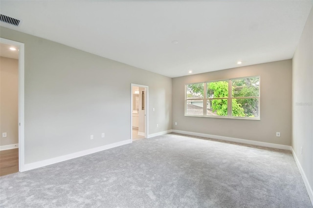 unfurnished room with baseboards, visible vents, and recessed lighting