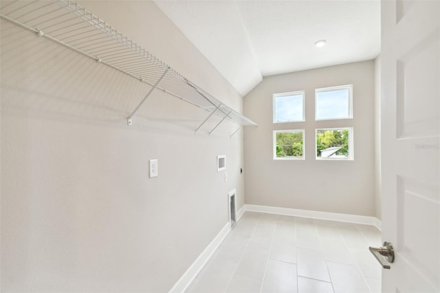 washroom with hookup for a washing machine, hookup for an electric dryer, laundry area, visible vents, and baseboards