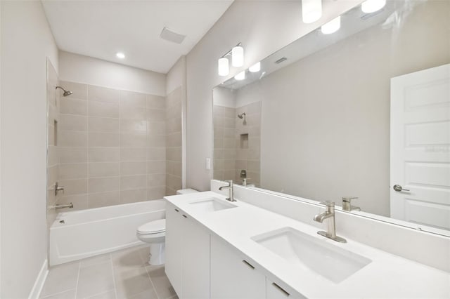 bathroom with toilet, tile patterned flooring, bathtub / shower combination, and a sink