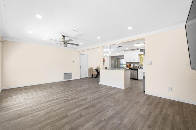1131 60th Ave S, Saint Petersburg, FL 33705 - unfurnished living room with wood finished floors, baseboards, ceiling fan, and recessed lighting