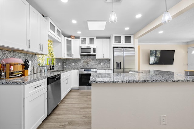 1131 60th Ave S, Saint Petersburg, FL 33705 - kitchen featuring appliances with stainless steel finishes, a sink, decorative backsplash, white cabinets, and recessed lighting