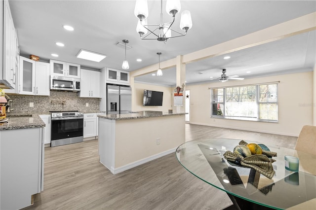 1131 60th Ave S, Saint Petersburg, FL 33705 - kitchen featuring appliances with stainless steel finishes, recessed lighting, light wood-style floors, a chandelier, and tasteful backsplash