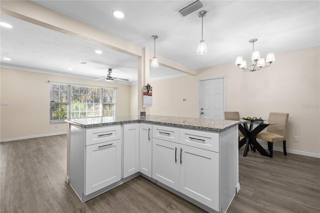 1131 60th Ave S, Saint Petersburg, FL 33705 - kitchen featuring baseboards, dark wood-type flooring, white cabinets, recessed lighting, and beamed ceiling