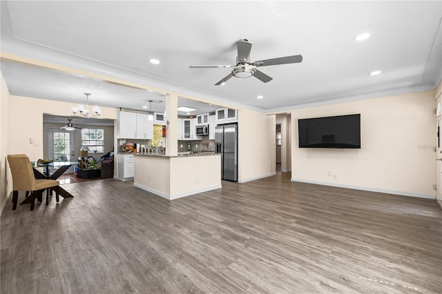 1131 60th Ave S, Saint Petersburg, FL 33705 - living area featuring a ceiling fan, dark wood-style flooring, baseboards, recessed lighting, and a chandelier