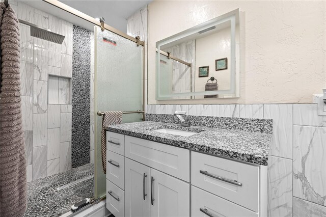 1131 60th Ave S, Saint Petersburg, FL 33705 - full bathroom featuring a shower stall, vanity, and a textured wall