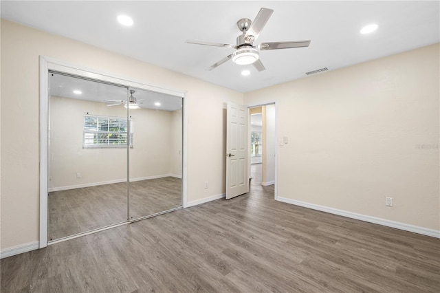1131 60th Ave S, Saint Petersburg, FL 33705 - unfurnished bedroom featuring wood finished floors, multiple windows, recessed lighting, and baseboards