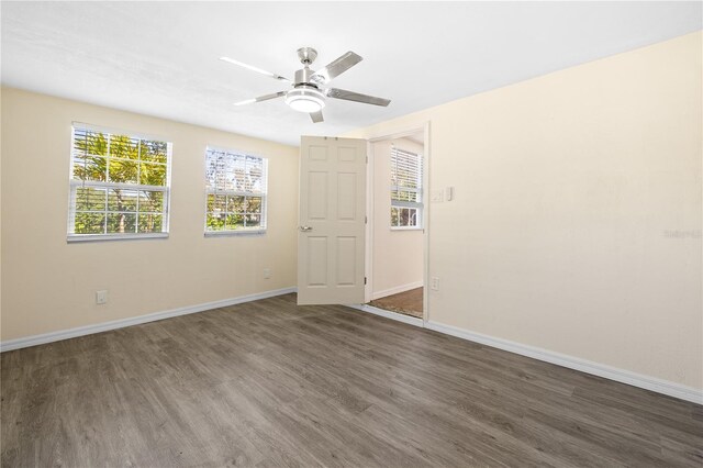 1131 60th Ave S, Saint Petersburg, FL 33705 - unfurnished room featuring wood finished floors, baseboards, plenty of natural light, and ceiling fan