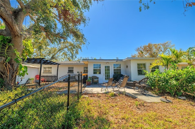1131 60th Ave S, Saint Petersburg, FL 33705 - rear view of house with stucco siding and a patio