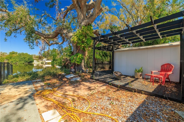1131 60th Ave S, Saint Petersburg, FL 33705 - view of yard featuring a pergola, a patio area, and a water view