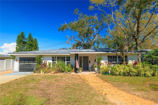 1131 60th Ave S, Saint Petersburg, FL 33705 - ranch-style house with stucco siding, a garage, and driveway