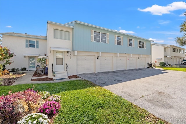 view of property with aphalt driveway and a front yard