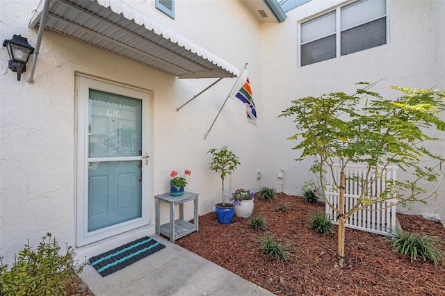 doorway to property with stucco siding