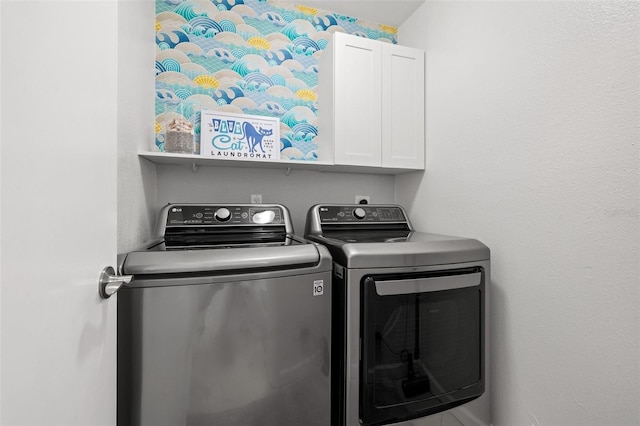 laundry area with cabinet space and washing machine and clothes dryer