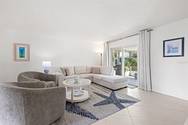 living area with tile patterned flooring and a textured ceiling