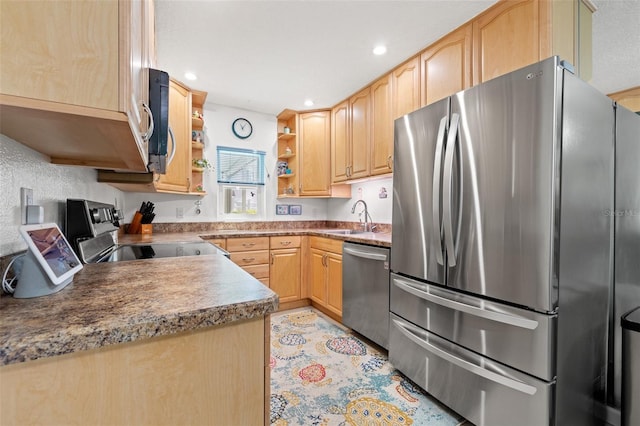 kitchen featuring appliances with stainless steel finishes, light brown cabinetry, a sink, and open shelves