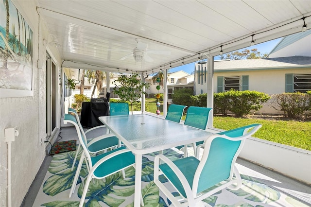 sunroom / solarium featuring a ceiling fan