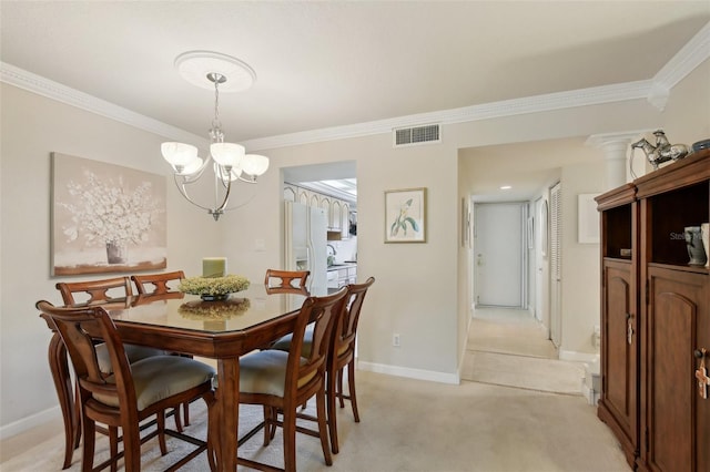 dining area with baseboards, visible vents, light colored carpet, ornamental molding, and an inviting chandelier