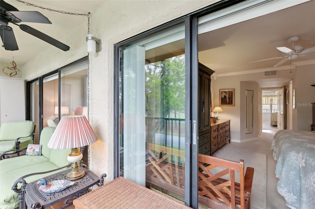 bedroom with a sunroom, baseboards, visible vents, access to exterior, and crown molding