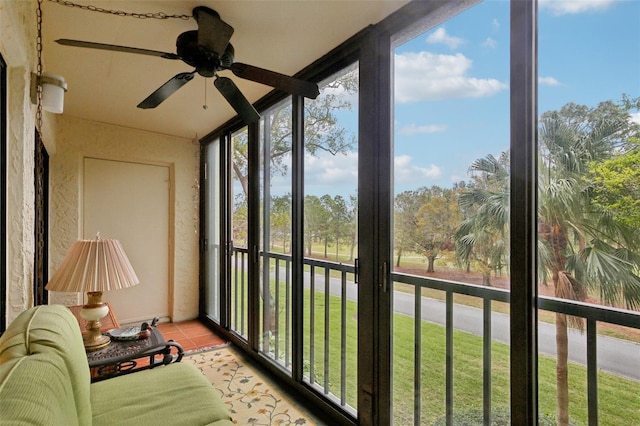 sunroom featuring a ceiling fan