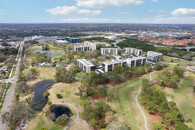 drone / aerial view featuring a view of city, a water view, and golf course view