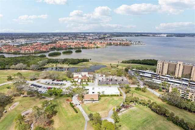 birds eye view of property with a water view and view of golf course