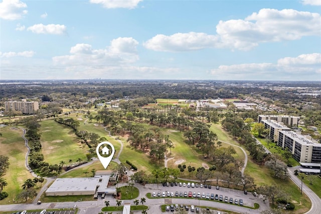 birds eye view of property featuring golf course view and a city view