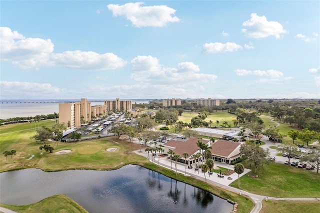 drone / aerial view with a view of city, a water view, and golf course view